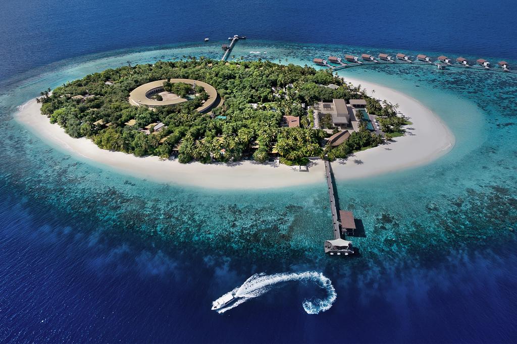 Aerial view of a luxurious private island resort in the Maldives.