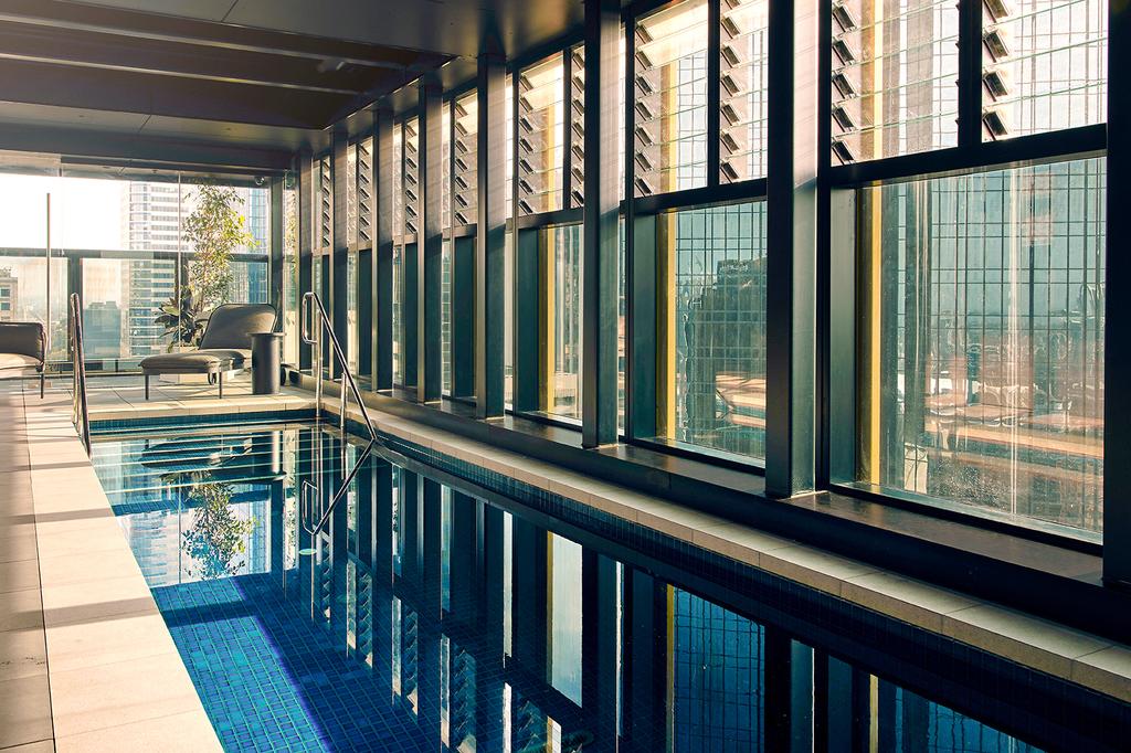 Rooftop pool with city views at a Quincy Hotel Melbourne.