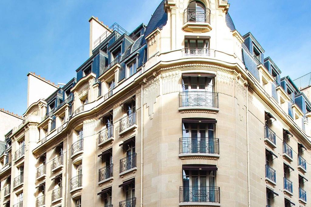 Elegant Haussmannian façade of Parisian Sofitel hotel near Champs-Élysées.