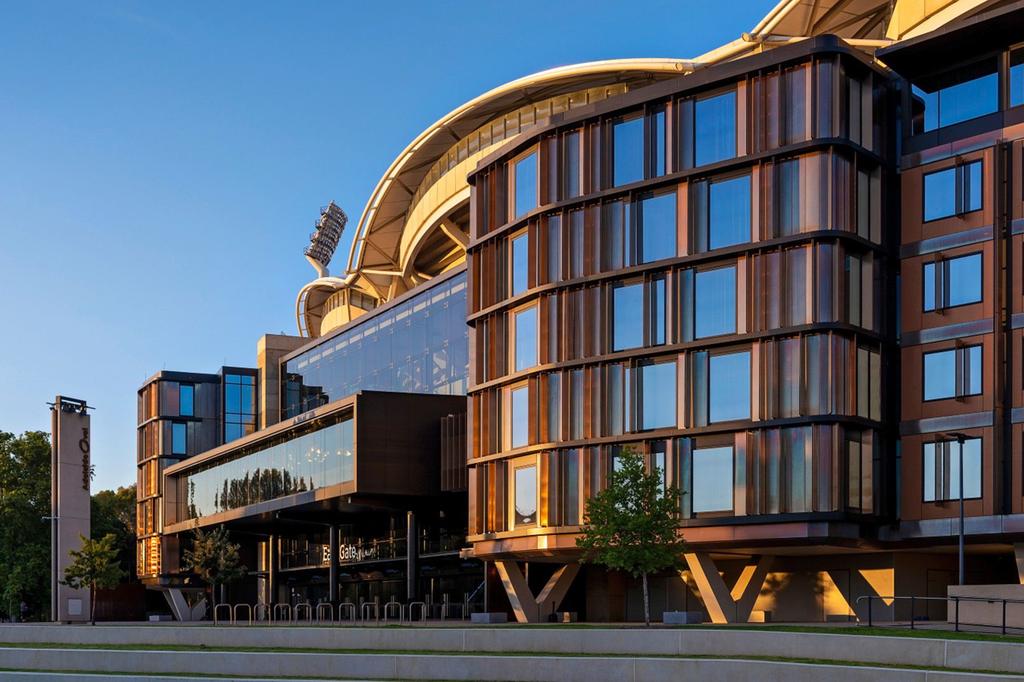 Exterior view of the Adelaide Oval's stadium hotel at sunset.