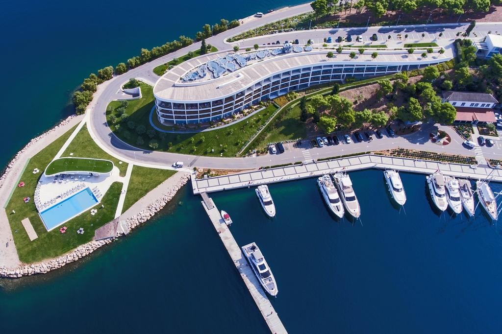 Aerial view of D-Resort Šibenik with infinity pool and adjacent marina.