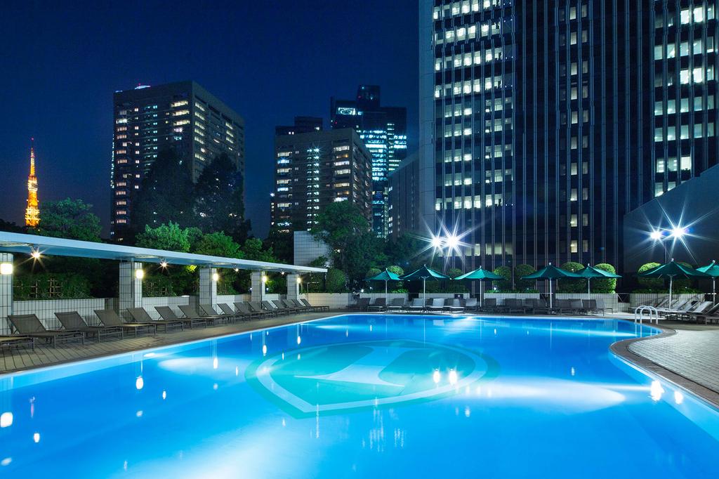 Luxurious outdoor pool at InterContinental Tokyo with city skyscrapers at night.