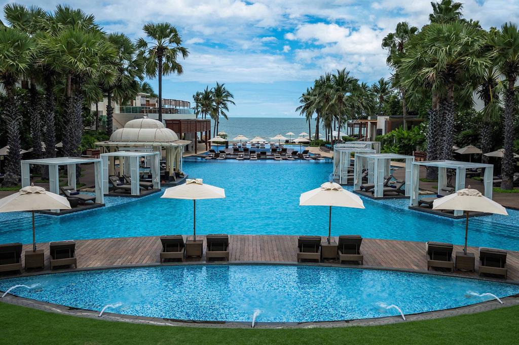 Luxurious pool area at a beachfront resort in Hua Hin, Thailand.