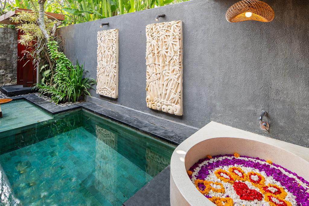 Private villa pool with floral decoration at Seminyak Sanctuary Villa.