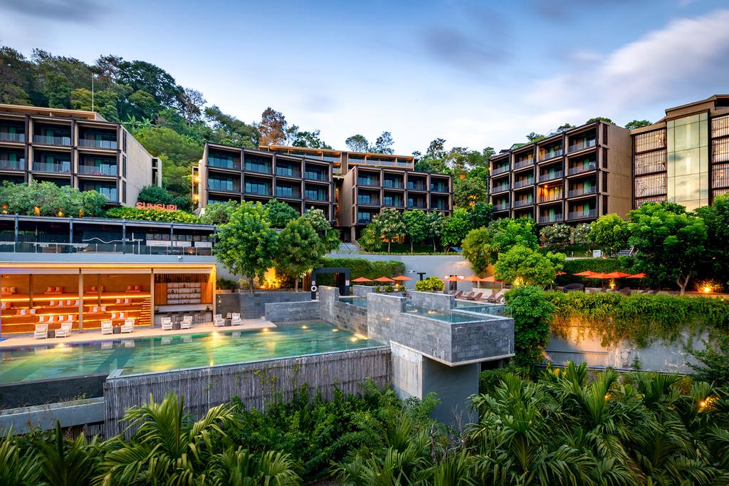 Hillside SUNSURI PHUKET, Nai Harn Beach, with lush greenery and a scenic pool area.