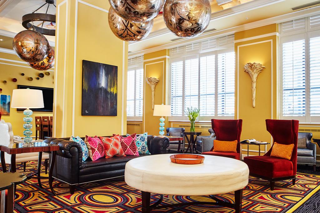 Elegant hotel lobby with stylish furniture and decorative lighting.