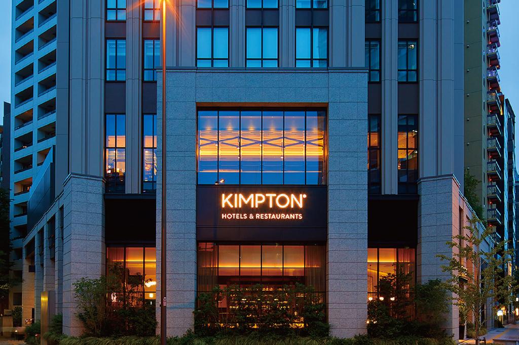 Kimpton Shinjuku Tokyo exterior at dusk with illuminated signage.