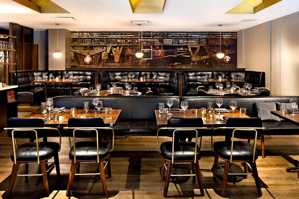 Elegant dining area at Kimpton Hotel Monaco Baltimore, featuring plush seating and decor.