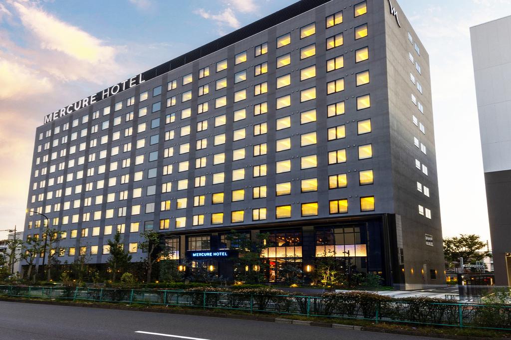 Contemporary hotel near Haneda Airport in Tokyo with illuminated windows.