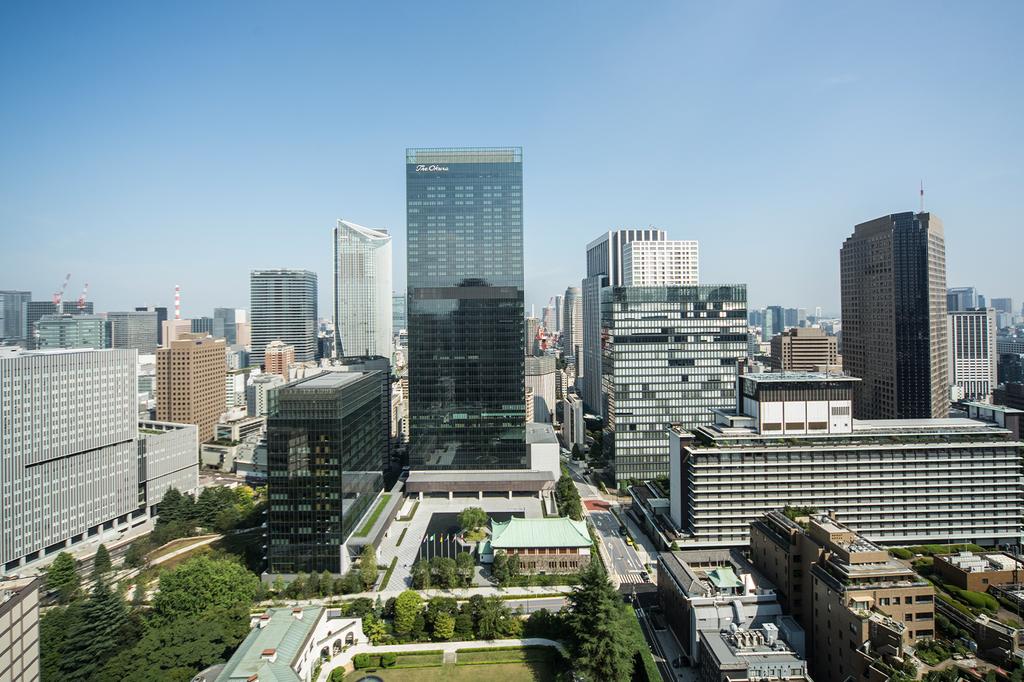 Aerial view of The Okura Tokyo hotel amidst city skyscrapers.