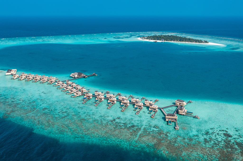 Aerial view of overwater villas on Turtle Island, Maldives.
