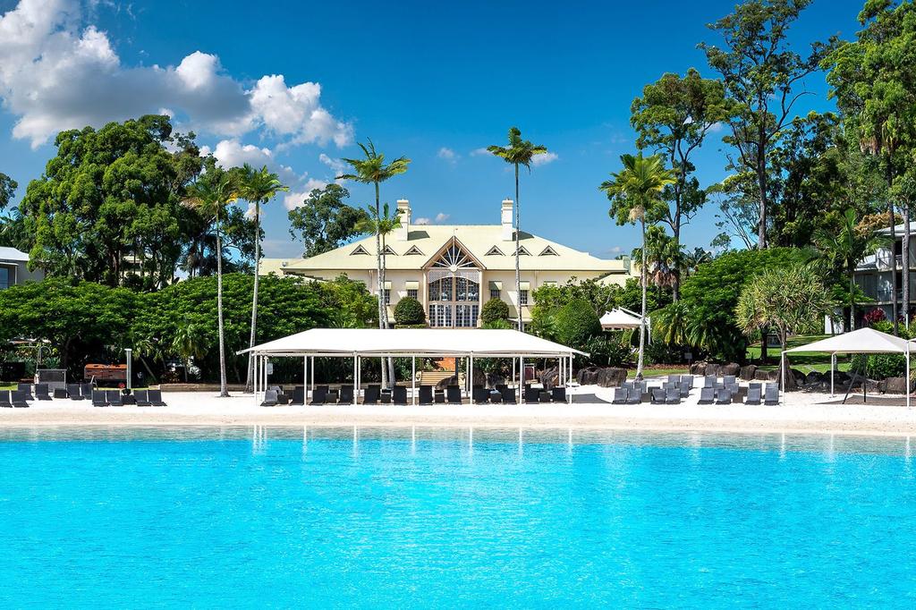 A luxurious lagoon pool at InterContinental Sanctuary Cove Resort, an IHG Hotel with tropical gardens.
