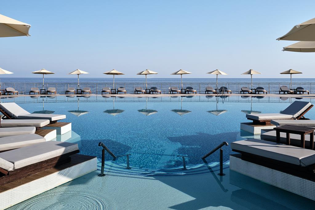 Luxurious pool with ocean view at The Royal Blue Resort & Spa on Crete.