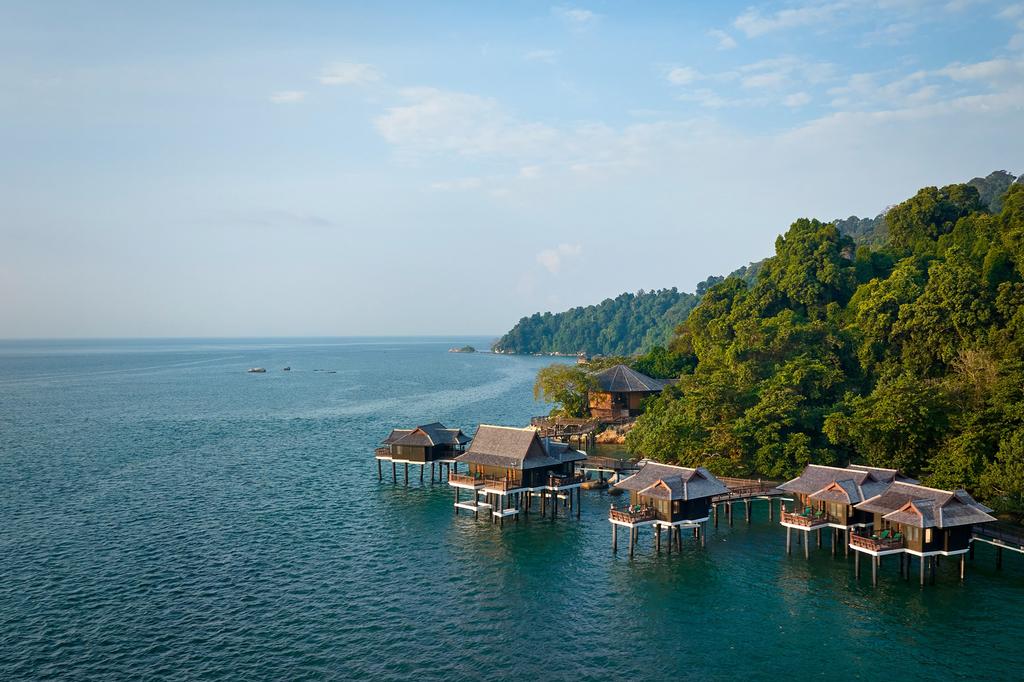 Overwater villas at a lush private island resort in Malaysia.
