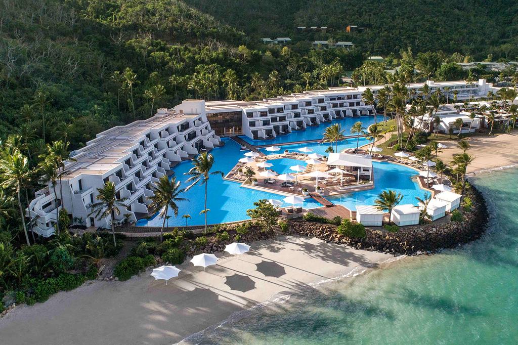 Aerial view of luxurious Hayman Island resort with large pool and ocean access.  