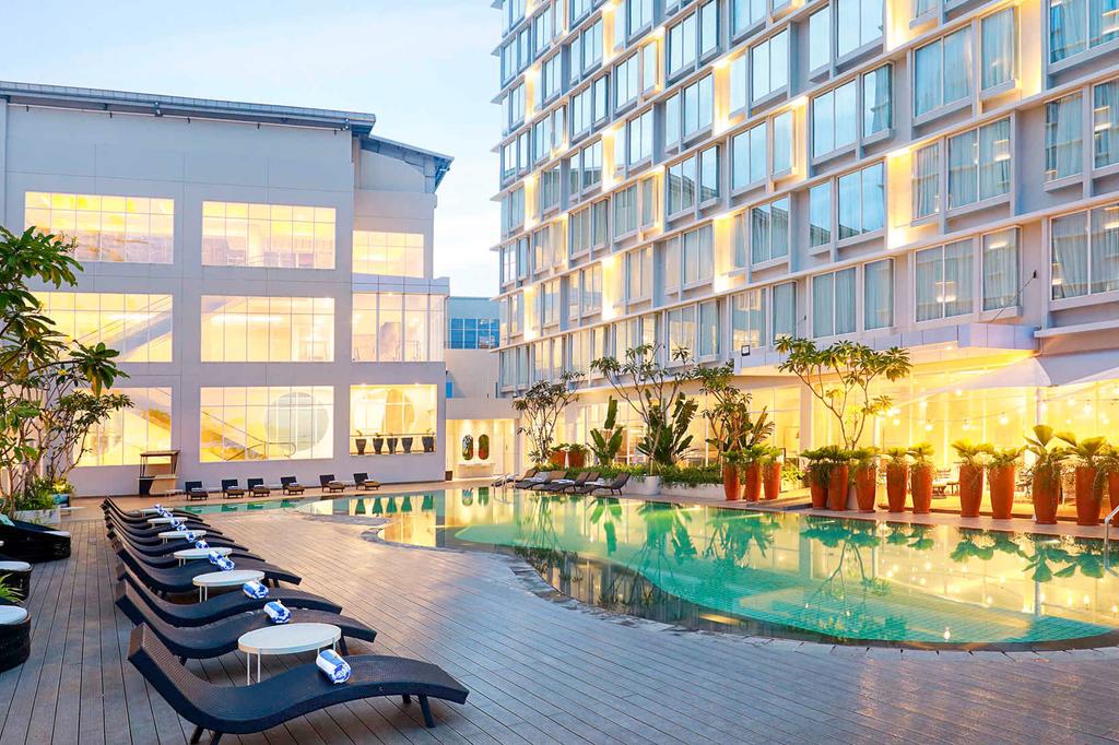 Modern hotel with a pool and lounge chairs in Samarinda.
