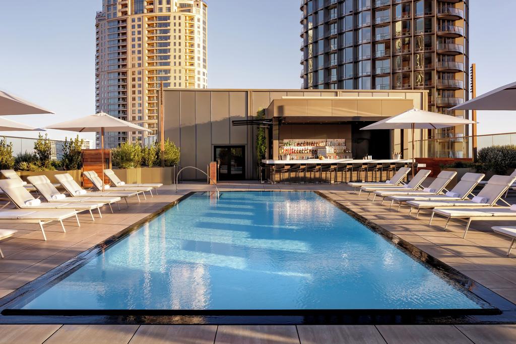 Rooftop infinity pool with skyline views and a stylish pool bar in LA.
