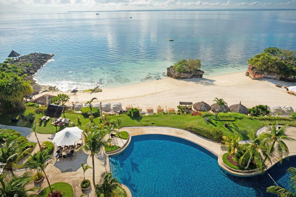 A tropical paradise on Mactan Island with a pool and beachfront view.