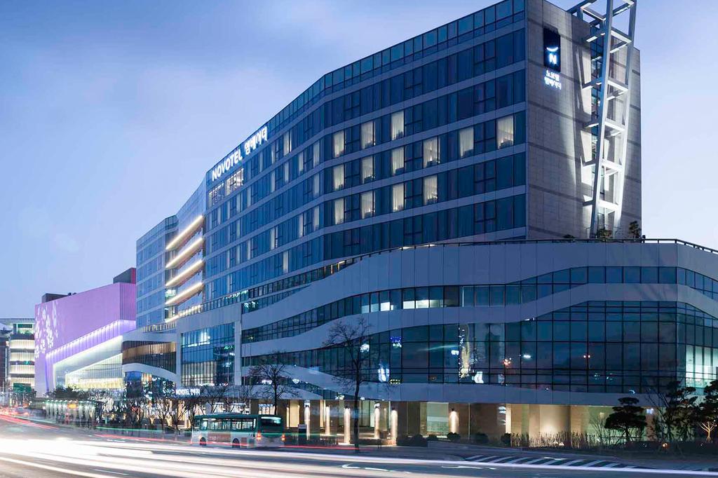 Contemporary hotel exterior in Suwon, South Korea at dusk.