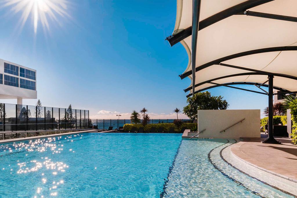 Luxurious pool area at Peppers Broadbeach with ocean views.