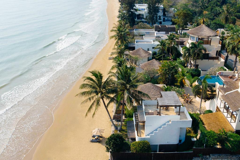 Aerial view of Aleenta Hua Hin Resort near a sandy beach.