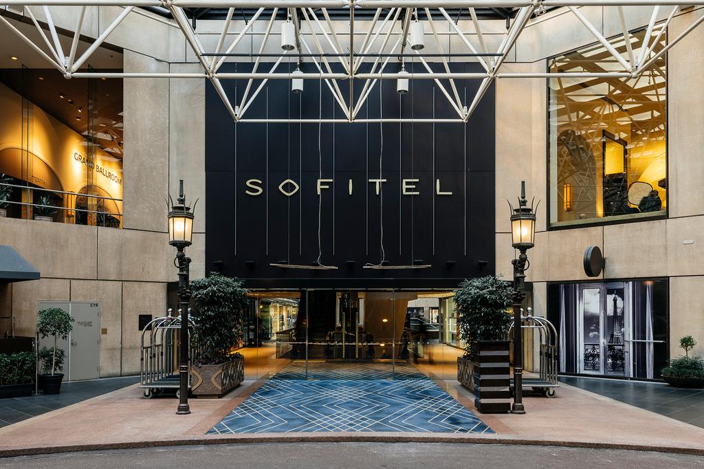 Entrance of Sofitel Melbourne with elegant design and signage.