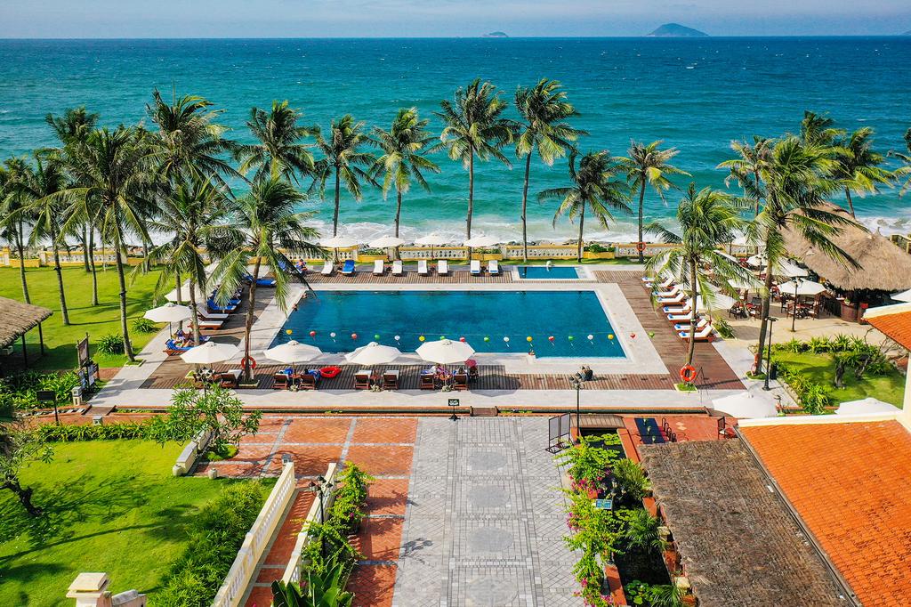 Victoria Hoi An Beach Resort & Spa with pool, palm trees, and ocean view in Hoi An. 