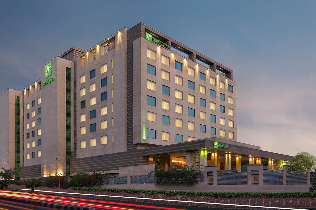 Holiday Inn Jaipur City Centre hotel exterior illuminated at dusk.
