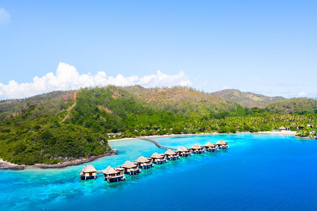 Aerial view of luxury Fijian resort over turquoise lagoon on Malolo Island.