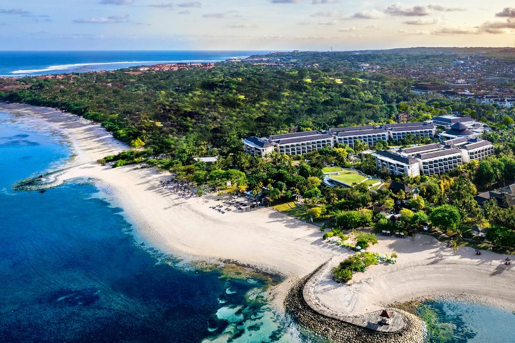 Aerial view of Sofitel Bali Nusa Dua Beach Resort beside a pristine coastline.