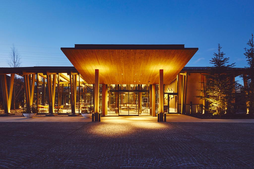 Exterior of Hotel Indigo Karuizawa at twilight, warmly lit and inviting.