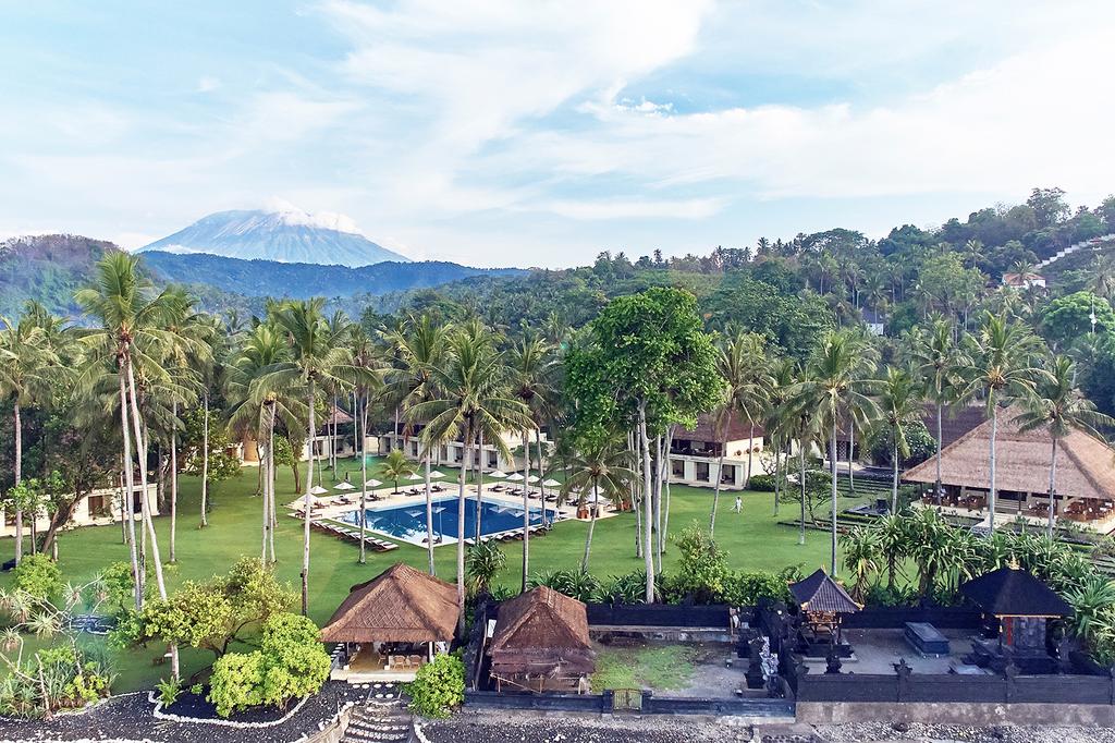 A serene seaside resort in Bali with lush greenery and pool view.