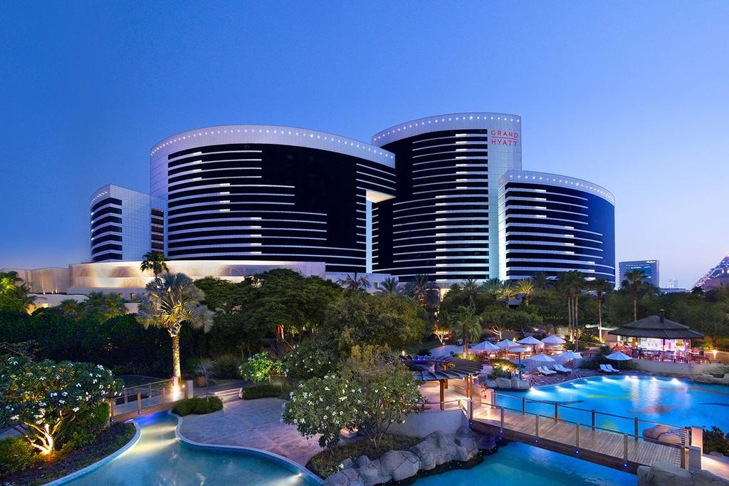 Exterior view of the luxurious Grand Hyatt Dubai as night falls