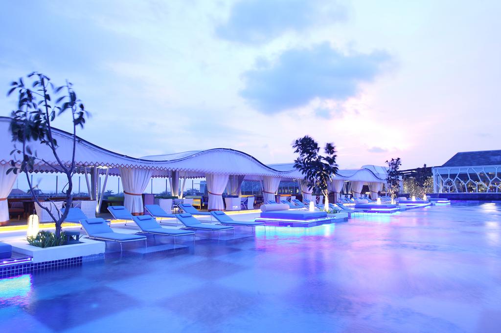TS Suites Seminyak's sky-high infinity pool at sunset.