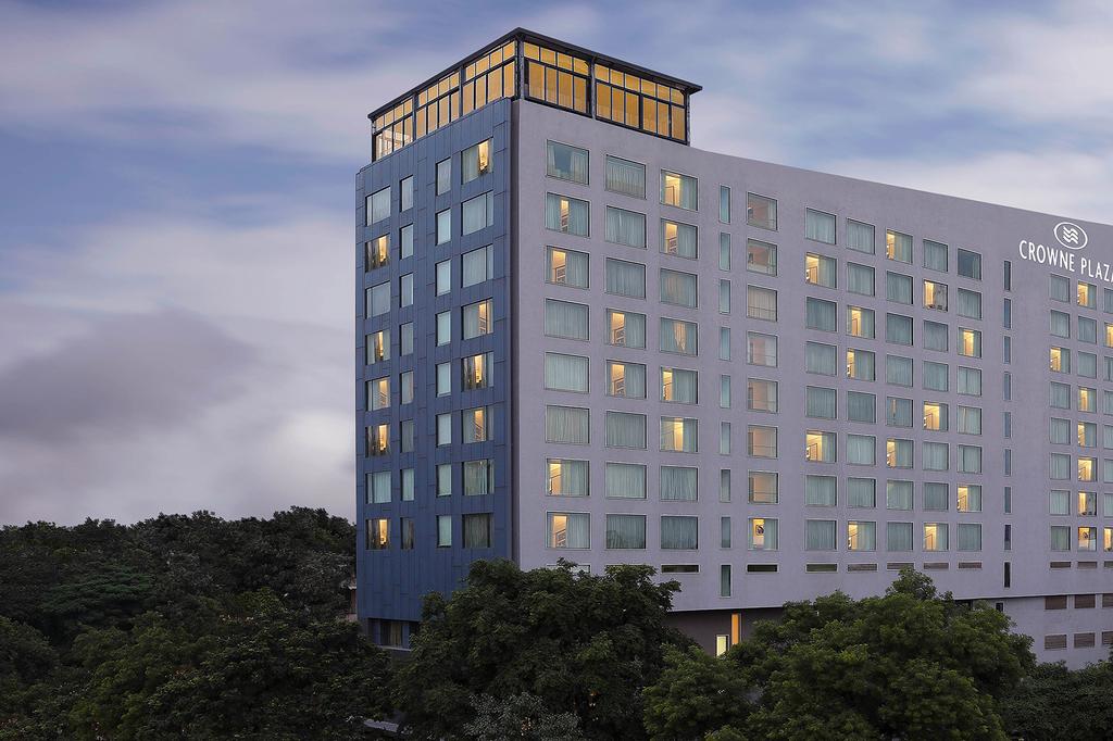 Crowne Plaza Pune City Centre hotel exterior with lush green surroundings.