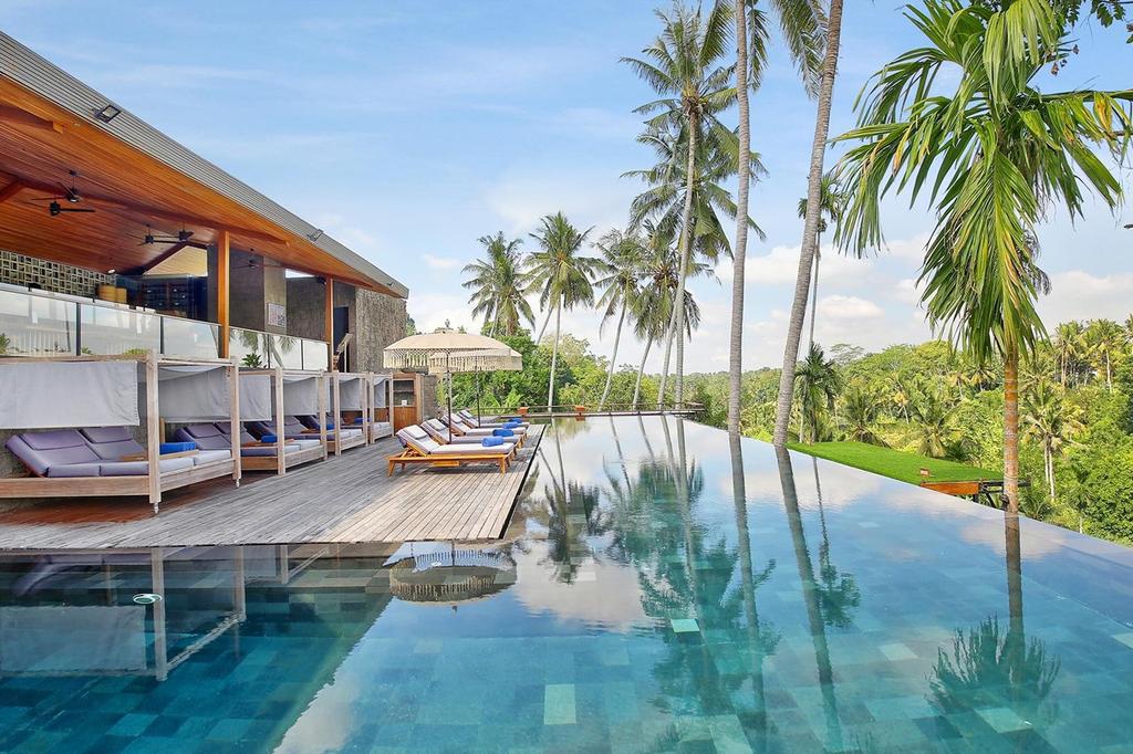 Infinity pool with a jungle view at Kaamala Resort Ubud.