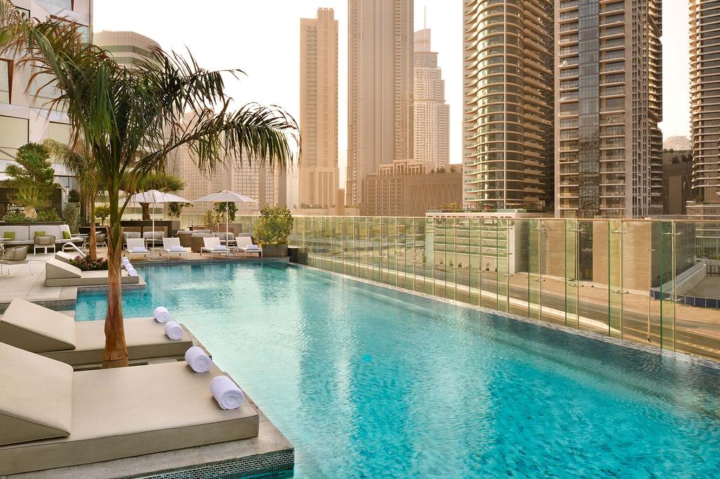 Poolside at Hotel Indigo Dubai Downtown with city skyline views.