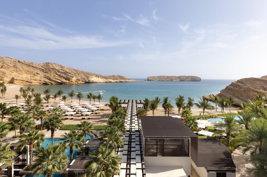 Stunning view of Jumeirah Muscat Bay with beach and ocean.
