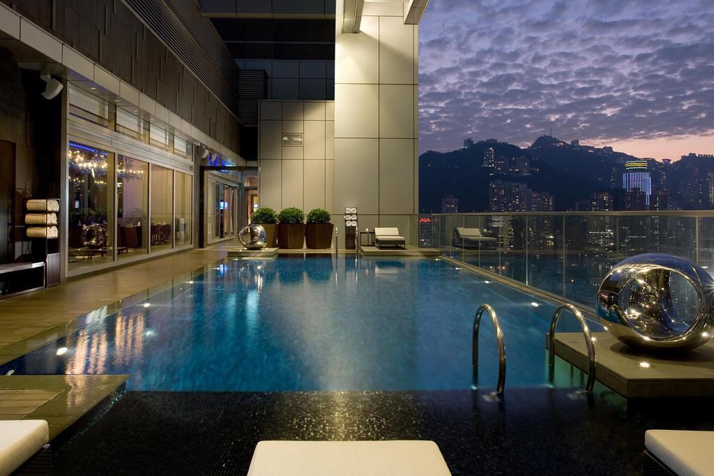 Rooftop pool at Crowne Plaza Hong Kong with city skyline view.