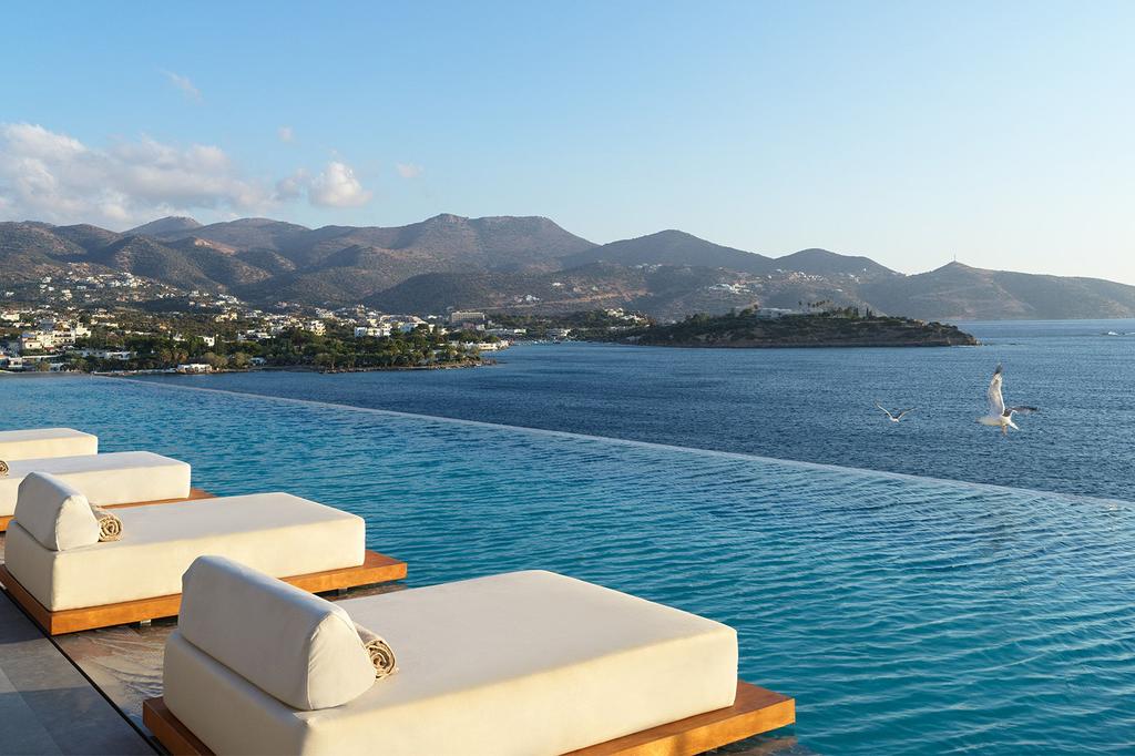 Infinity pool overlooking Mirabello Bay at a luxury coastal retreat.