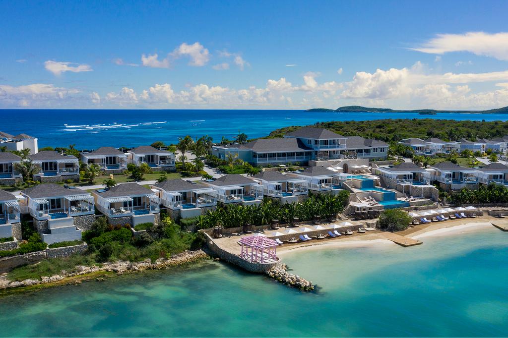 Luxury villas overlooking turquoise waters at Hammock Cove Resort, Antigua.