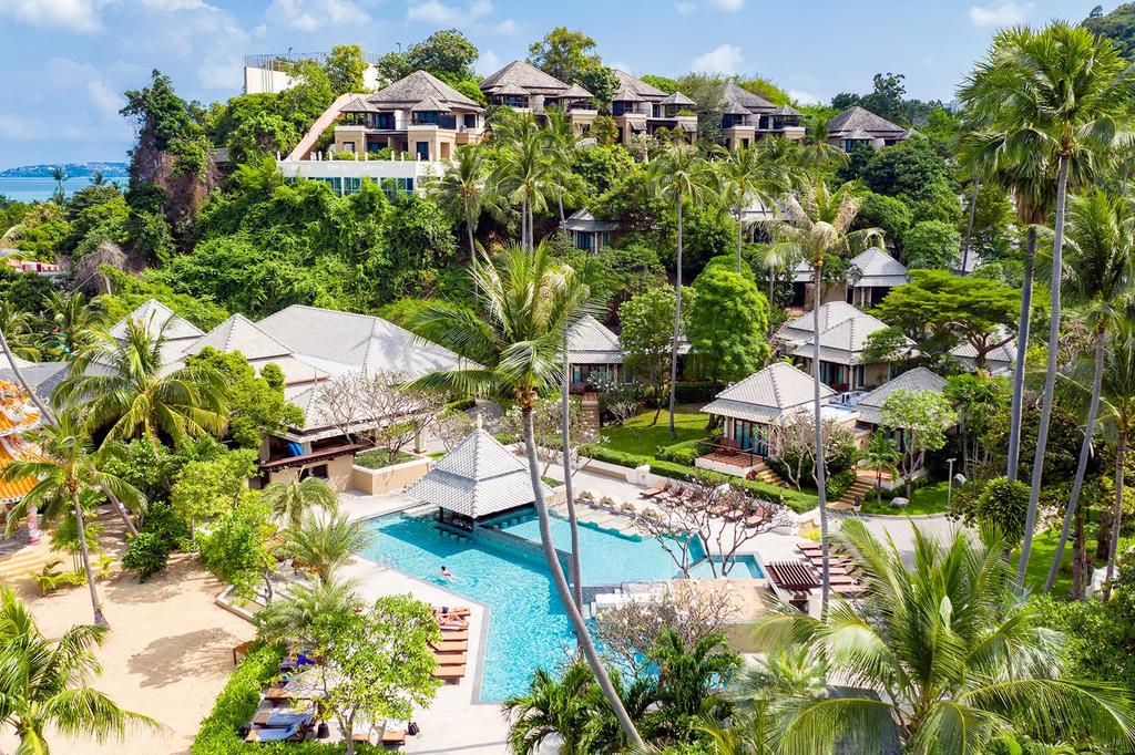 A lush beachfront resort in Koh Samui with a pool and villas. 