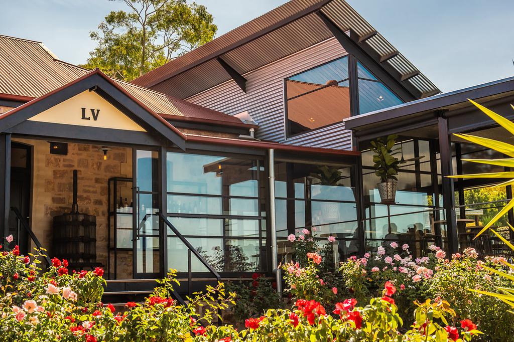 Charming Longview Vineyard retreat with lush gardens and rustic architecture in Adelaide Hills.