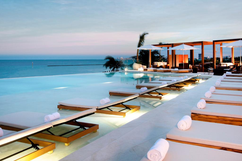 Infinity pool with ocean views at a luxury Cancun resort.
