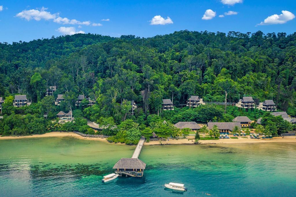 Aerial view of beachfront villas on Gaya Island surrounded by rainforest.