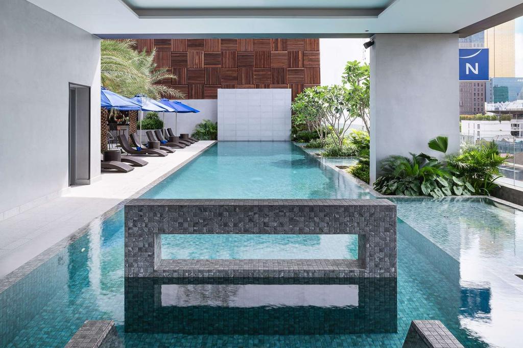 Sleek outdoor pool area in Phnom Penh city hotel.