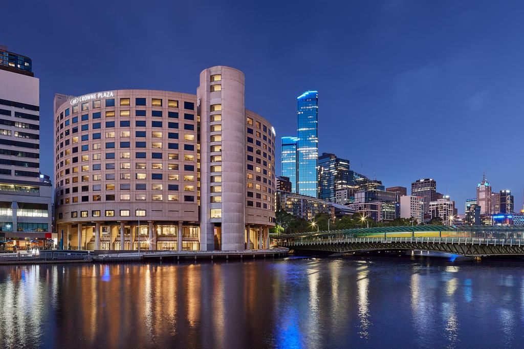 The Crowne Plaza Melbourne hotel beside the Yarra River at night.