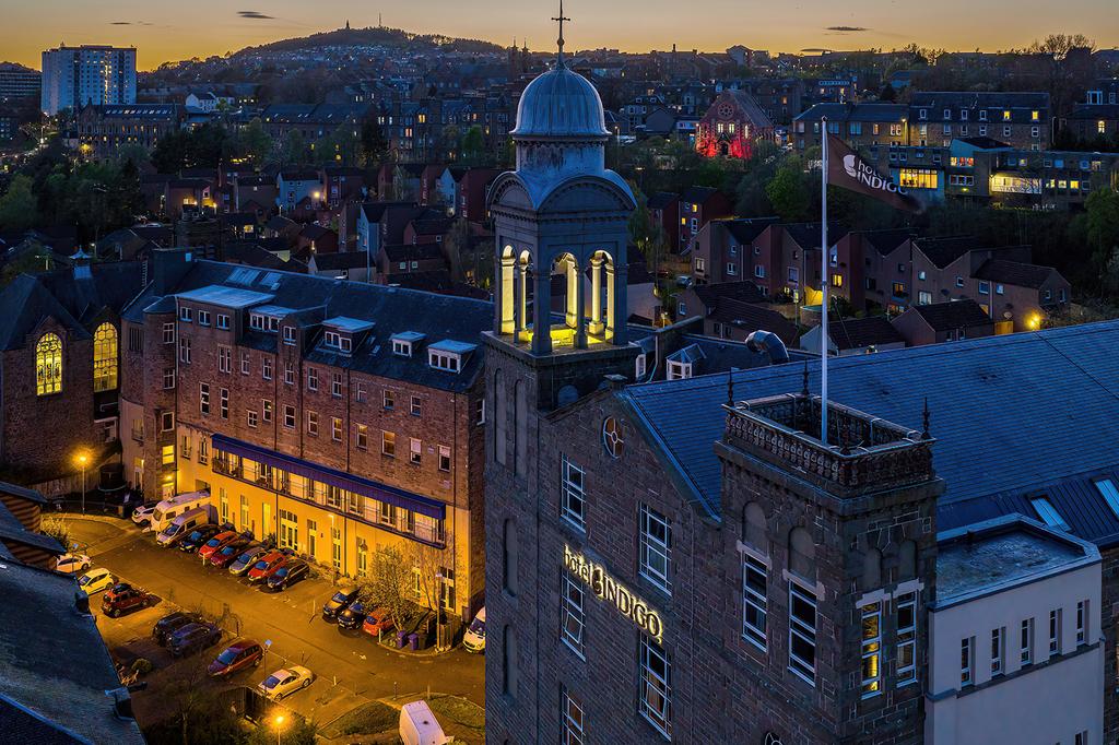 Scotland's Hotel Indigo Dundee with historic bell tower at dusk.