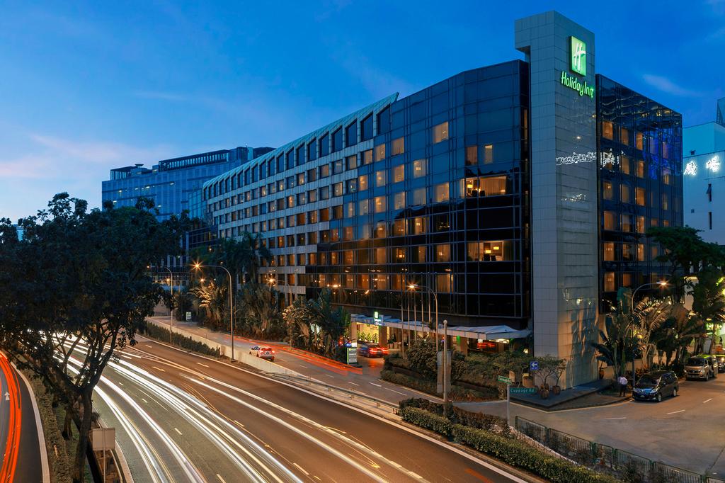 Exterior view of Holiday Inn Singapore Orchard City Centre at dusk.