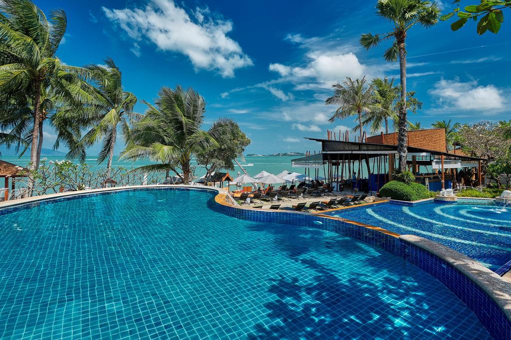 Pool at Bandara Spa Resort & Pool Villas, Samui, with palm trees overlooking Koh Samui's Bo Phut Beach.